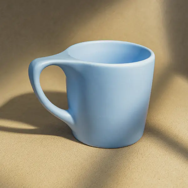 カスタムデザインのフラットリムセラミックコーヒーカップで、滑らかな釉薬とエルゴノミクスに配慮したハンドルが特徴です