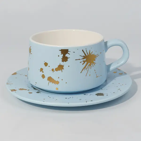 手描きのスプラッターデザインが施された金箔陶器のコーヒーマグの側面図